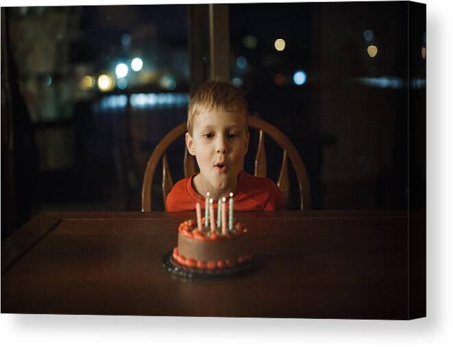 Child Canvas Print featuring the photograph Little blowing out candles by Annie Otzen