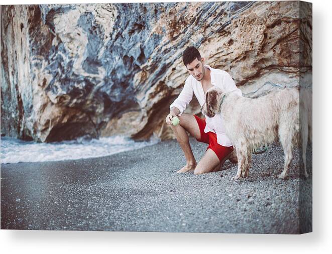 Pets Canvas Print featuring the photograph Man and his friend at the beach by South_agency