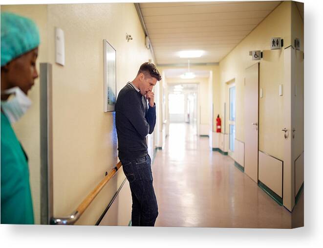 Medical Building Canvas Print featuring the photograph Man filling nervous while waiting in hospital corridor by Luis Alvarez