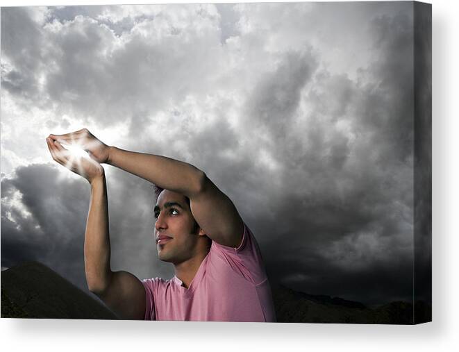 Young Men Canvas Print featuring the photograph Man trying to catch sun rays by Hemant Mehta