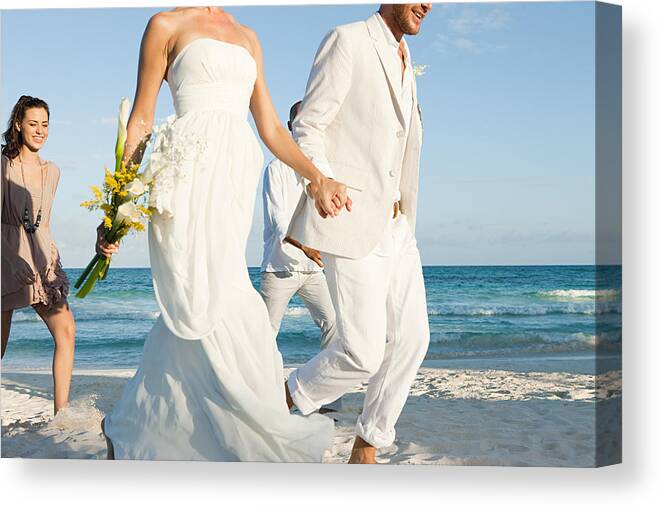 Groom Canvas Print featuring the photograph Married couple on beach with friends by Image Source