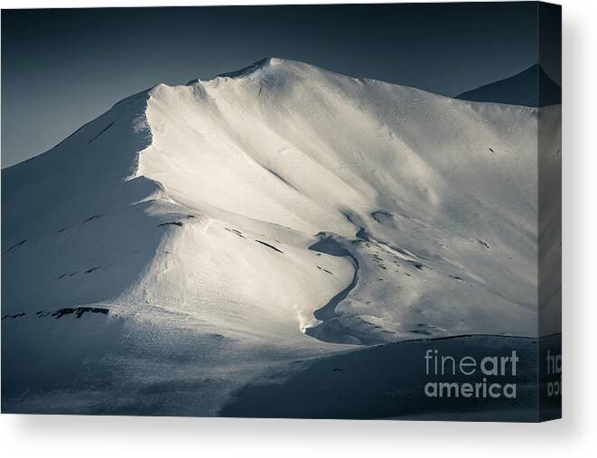 Landscape Canvas Print featuring the photograph Mountain detail of a snowy peak in Svalbard, looking along the ridge. Split toned, low key image. by Jane Rix