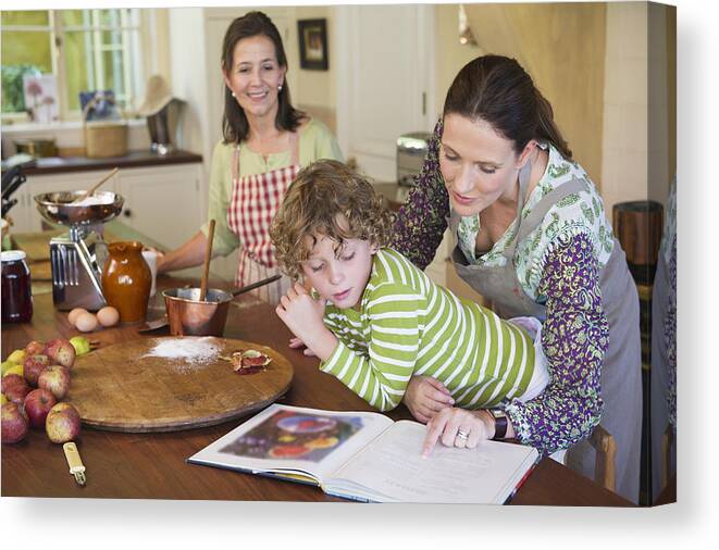 Domestic Room Canvas Print featuring the photograph Multi generation family cooking food at kitchen by Eric Audras