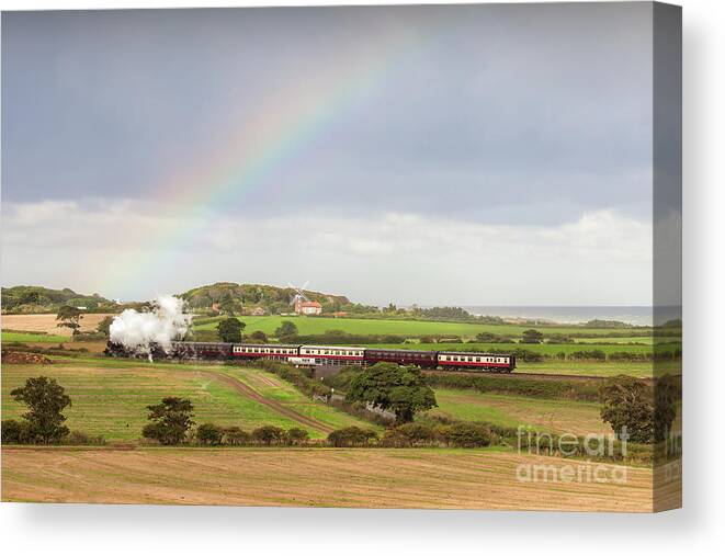 Weybourne Canvas Print featuring the photograph Norfolk steam train with Weybourne windmill and rainbow by Simon Bratt