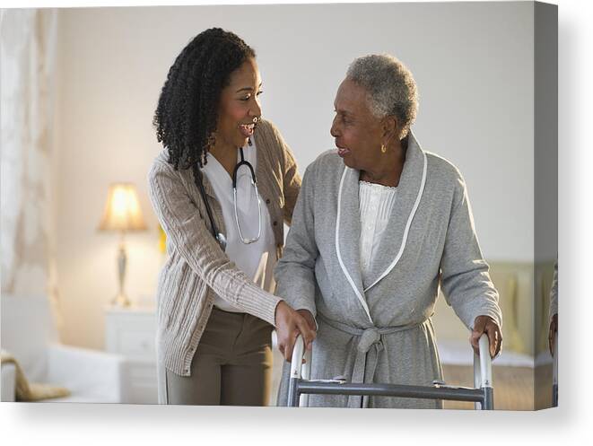 Expertise Canvas Print featuring the photograph Nurse helping woman walk with walker by JGI/Tom Grill