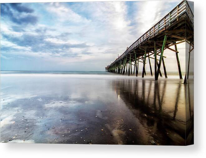 North Carolina Fishing Pier Canvas Print featuring the photograph Oceanna Pier With Blue Skies and Dark Clouds Reflected by Bob Decker