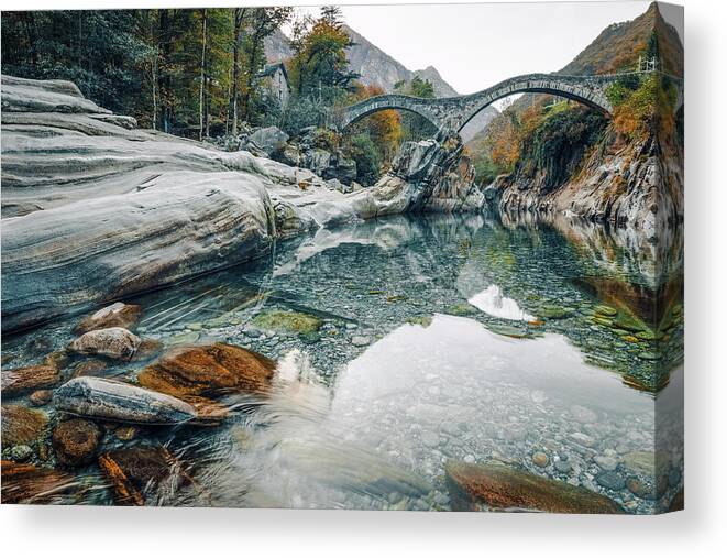 2018 Canvas Print featuring the photograph Old stone bridge over crystal clear water by Benoit Bruchez