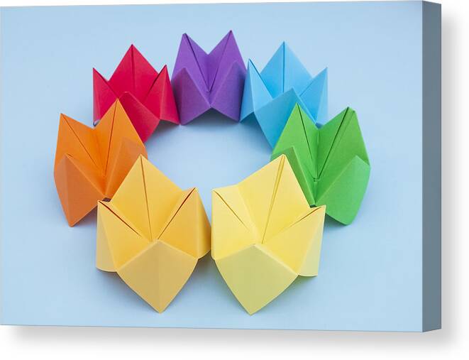 Dublin Canvas Print featuring the photograph Paper Fortune Tellers arranged by colour on a blue background by Catherine MacBride
