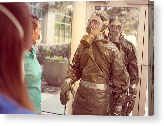 Working Canvas Print featuring the photograph People in hazmat suits entering office for contagious outbreak by SDI Productions