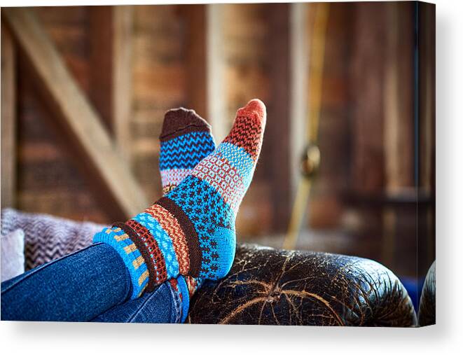 Tranquility Canvas Print featuring the photograph Person wearing patterned socks with feet up on leather sofa by 10'000 Hours