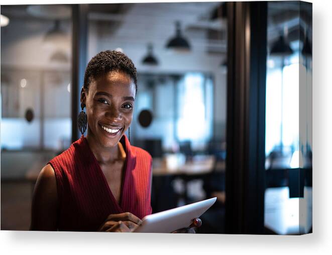 Expertise Canvas Print featuring the photograph Portrait of businesswoman using digital tablet at office by FG Trade