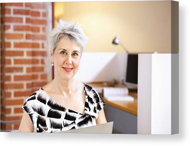 Corporate Business Canvas Print featuring the photograph Portrait of smiling, mature business woman by Compassionate Eye Foundation/Robert Kent