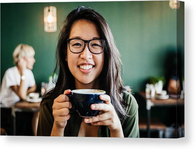 People Canvas Print featuring the photograph Portrait Of Young Woman Smiling Drinking Coffee by Tom Werner