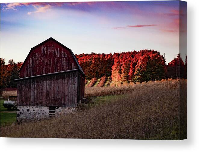 Michigan Fall Canvas Print featuring the photograph Red barn at sunrise with fall colors in northern Michigan by Eldon McGraw