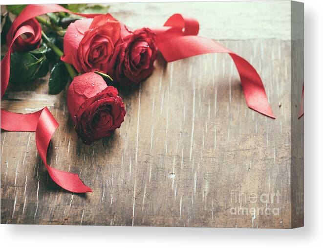 Roses Canvas Print featuring the photograph Red roses with red ribbon on wooden table by Jelena Jovanovic