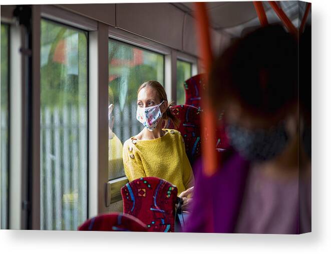 Protective Face Mask Canvas Print featuring the photograph Reflecting on Her Day by SolStock