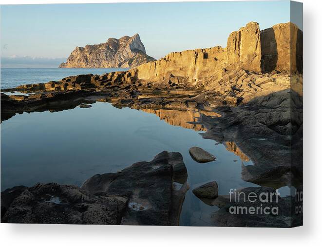 Mediterranean Canvas Print featuring the photograph Reflection of rocks in the calm Mediterranean Sea at sunrise 1 by Adriana Mueller