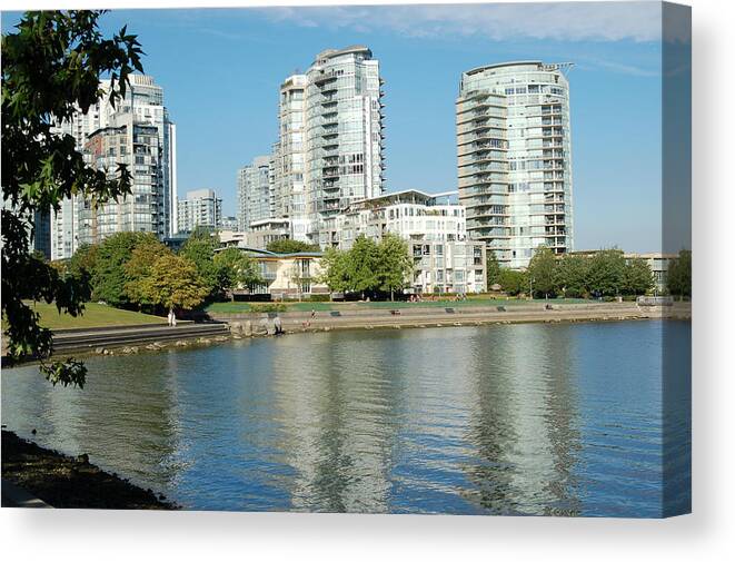 Buildings Canvas Print featuring the photograph Reflections of a City by James Cousineau