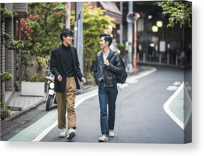 Young Men Canvas Print featuring the photograph Relaxed Japanese Male Friends Walking and Talking in Tokyo by AzmanL