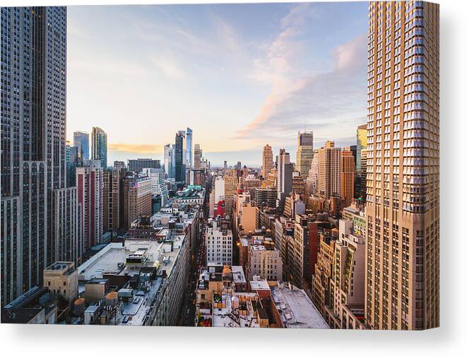 Downtown District Canvas Print featuring the photograph Rooftop view of Midtown Manhattan skyline, New York City by © Marco Bottigelli