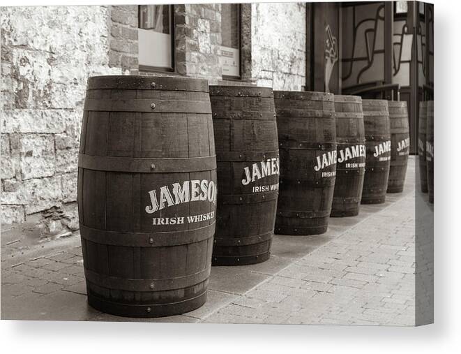 Jameson Distillery Canvas Print featuring the photograph Row of Whiskey Barrels Outside the Jameson Distillery in Dublin Ireland by Georgia Clare