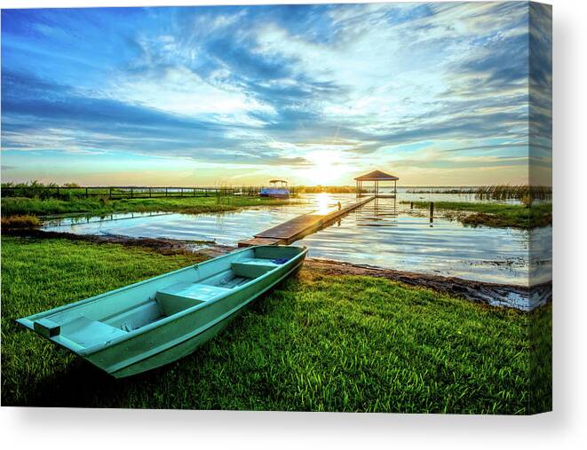 Docks Canvas Print featuring the photograph Rowboat at the Water's Edge by Debra and Dave Vanderlaan