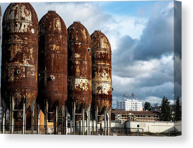 Rusty Tanks And White Herald Building Canvas Print featuring the photograph Rusty Tanks and White Herald Building by Tom Cochran