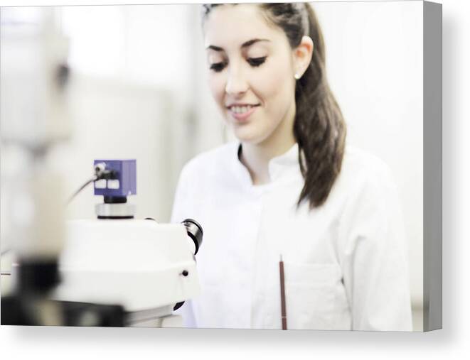 Microscope Canvas Print featuring the photograph Scientist using microscope in lab by Cultura/Sigrid Gombert