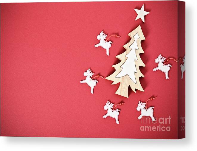 Seasonal Canvas Print featuring the photograph Seasonal greeting card concept with Christmas tree and raindeer by Mendelex Photography