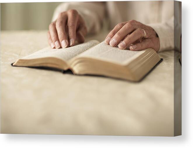 One Man Only Canvas Print featuring the photograph Senior man reading Bible, close-up of hands by Thomas Northcut