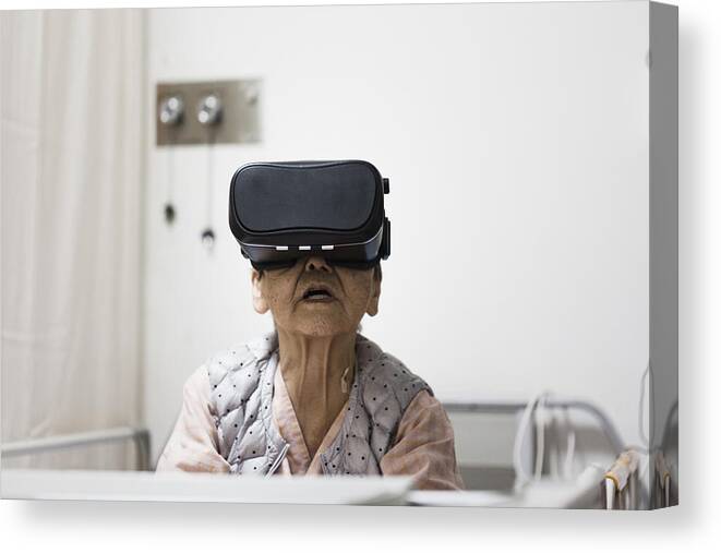 Augmented Reality Canvas Print featuring the photograph Senior woman in the hospital wearing a Virtual Reality headset by Kohei Hara