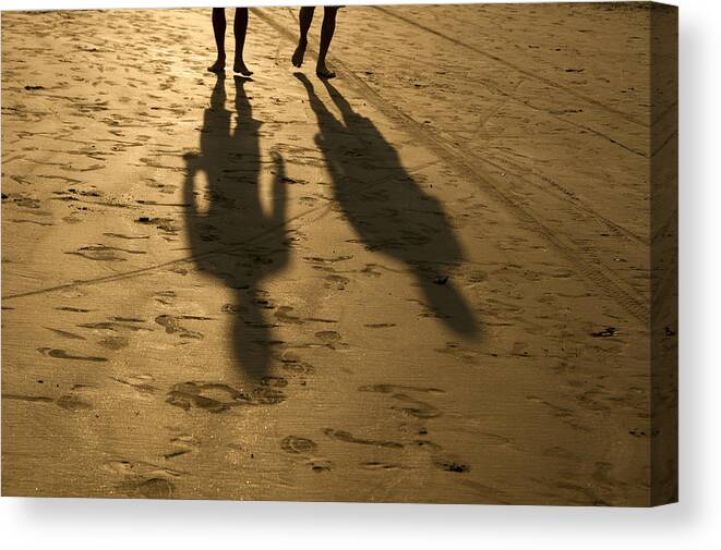 Shadow Canvas Print featuring the photograph Shadows of people walking during sunset on the beach. Santos, SP, Brazil by Priscila Zambotto