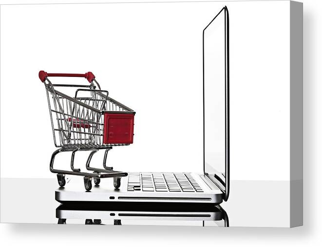 White Background Canvas Print featuring the photograph Shopping cart and laptop computer still life by David Crockett
