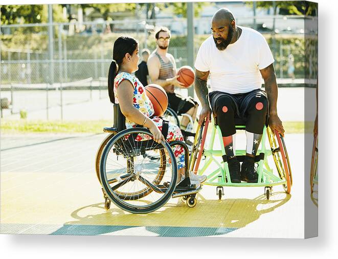 Expertise Canvas Print featuring the photograph Smiling young female adaptive athlete getting advice from adaptive basketball coach during practice on summer evening by Thomas Barwick