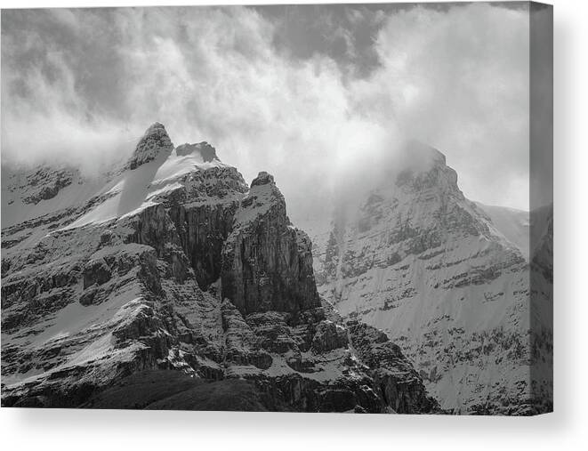 Mountain Drama Black And White Canvas Print featuring the photograph Snow Capped Peaks In Canada by Dan Sproul