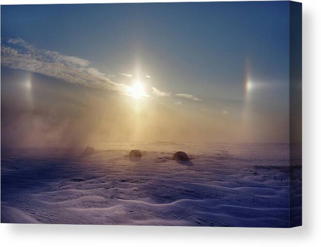 Sundogs Canvas Print featuring the photograph Sundogs and haybales in a blizzard-like ND snowscape by Peter Herman