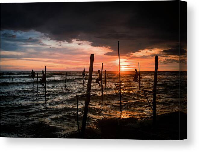 Fisherman Canvas Print featuring the photograph Sunset and Stilt Fishermen by Arj Munoz