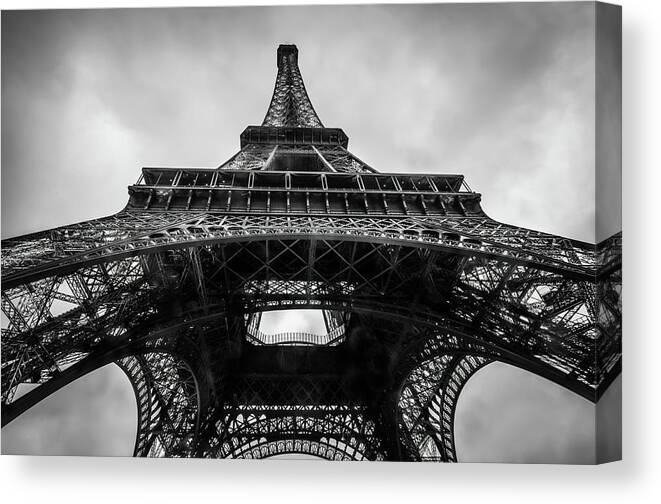 Eiffel Tower Canvas Print featuring the photograph The Eiffel Tower in Paris France Seen From Below in Black and White by Alexios Ntounas