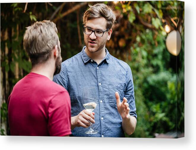 Young Men Canvas Print featuring the photograph Two Friends Chatting And Drinking At BBQ by Hinterhaus Productions