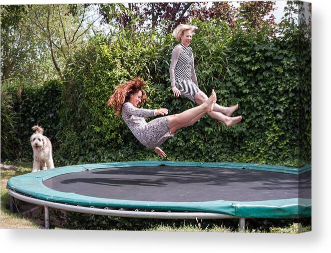 North Holland Canvas Print featuring the photograph Two women playing on trampoline by Lucy Lambriex