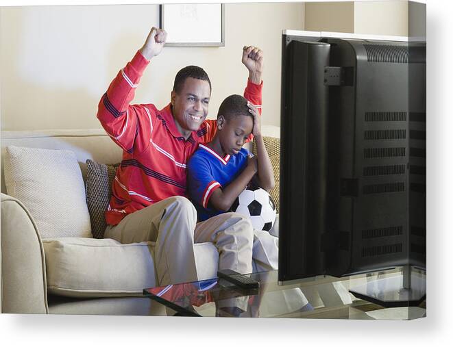 Three Quarter Length Canvas Print featuring the photograph USA, California, Los Angeles, Father and Son (12-13) watching sports on tv by Rob Lewine
