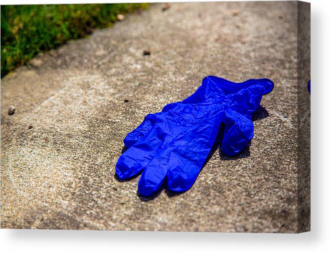 Cement Canvas Print featuring the photograph Used glove on pavement by Photo by Katkami