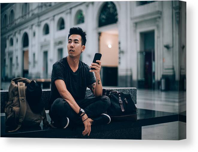 Cool Attitude Canvas Print featuring the photograph Using smart phone while waiting for my train by South_agency