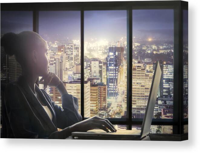 People Canvas Print featuring the photograph Woman at computer watching city by Buena Vista Images