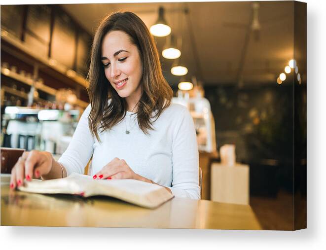 People Canvas Print featuring the photograph Woman Reading Book in Coffee Shop by RyanJLane