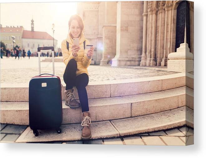 Electronic Banking Canvas Print featuring the photograph Woman traveling in Europe and using credit card for hotel reservation by Martin-dm