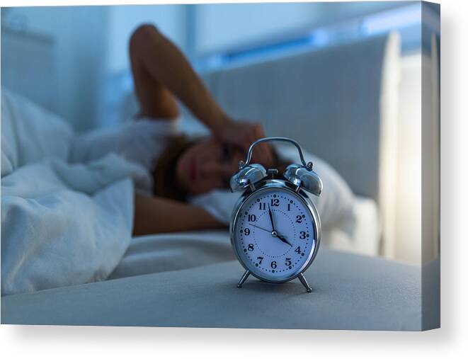 Problems Canvas Print featuring the photograph Young Beautiful Woman At Home Bedroom Lying In Bed Late At Night Trying To Sleep Suffering Insomnia Sleeping Disorder Or Scared On Nightmares Looking Sad Worried And Stressed by Stefanamer
