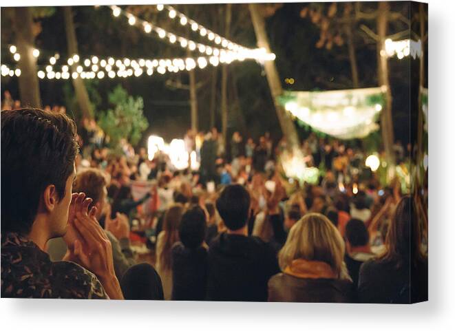 Young Men Canvas Print featuring the photograph Young man clapping in night music festival by Doble.d