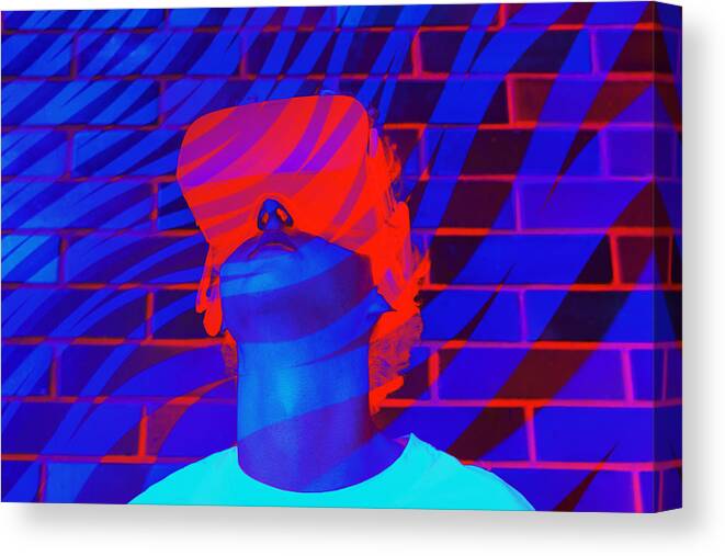 Smart Glasses Canvas Print featuring the photograph Young man or teenager in a white t-shirt wearing virtual reality Headset during the VR experience. by Iryna Veklich