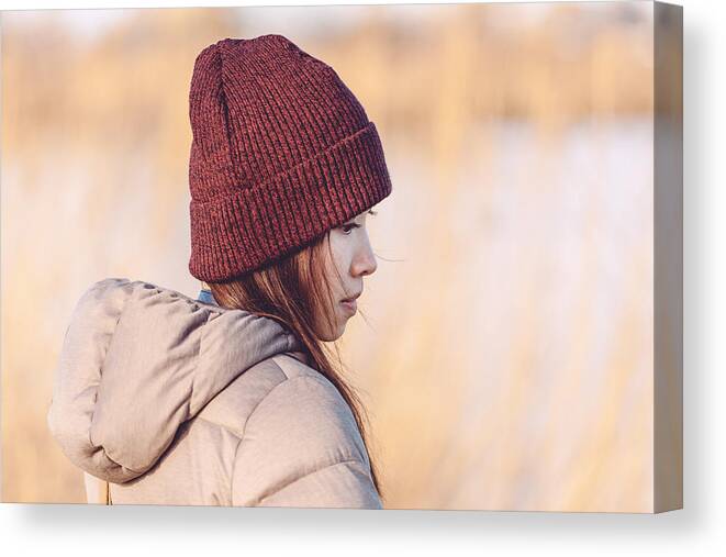 Tranquility Canvas Print featuring the photograph Young woman at sunset by Oscar Wong